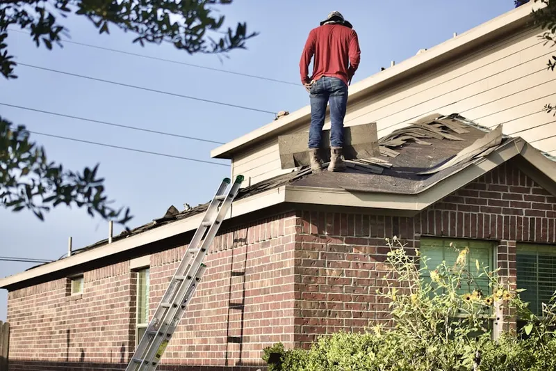 Professional roofer working on a residential roof in Gause